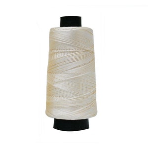 May include: A spool of off-white thread with a black plastic bobbin.