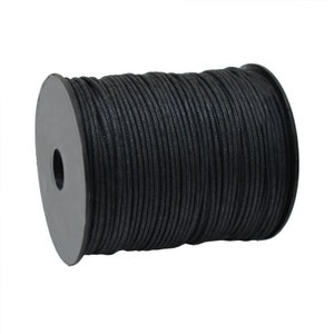 May include: A spool of black waxed cord. The cord is tightly wound around a gray plastic spool. The cord appears to be made of a durable material, suitable for various crafting and jewelry-making projects.