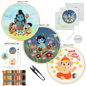 May include: Embroidery kit featuring three circular hoops with colorful Hindu deity designs. Includes thread, needles, scissors, and instructions. The designs depict various figures with vibrant colors and floral elements.