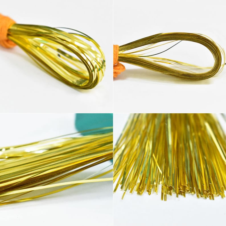 May include: A spool of gold metallic thread, perfect for crafting and adding a touch of sparkle to projects.