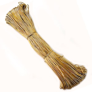 May include: A tightly bound bundle of gold-coloured cord. The cord is thin and flexible, and is secured in the middle with a similar cord. The item is likely intended for crafts or decorative purposes.