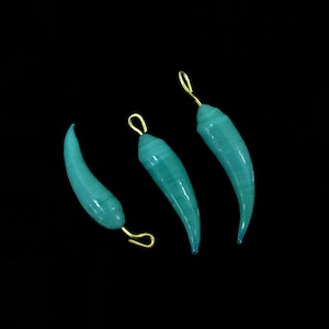 May include: Three teal green glass chili pepper charms with gold jump rings.