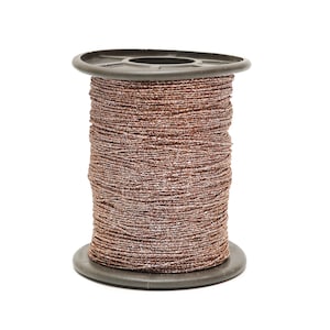 May include: A spool of metallic thread in a copper color with a silver sheen. The thread is tightly wound around a dark gray plastic spool. Ideal for crafting, sewing, or embellishing projects.