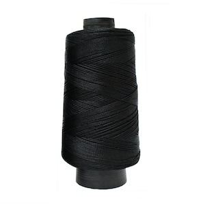 May include: A spool of black thread.