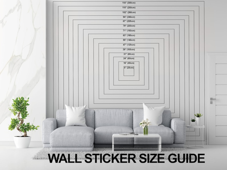 May include: A size guide for wall stickers, showing different sizes in inches and centimeters. The guide is displayed on a white wall with a gray couch in the foreground.