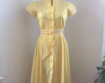Bright yellow 1940&#39;s/50&#39;s soft cotton day dress w/ lacey eyelet cut out at waist and pearl buttons
