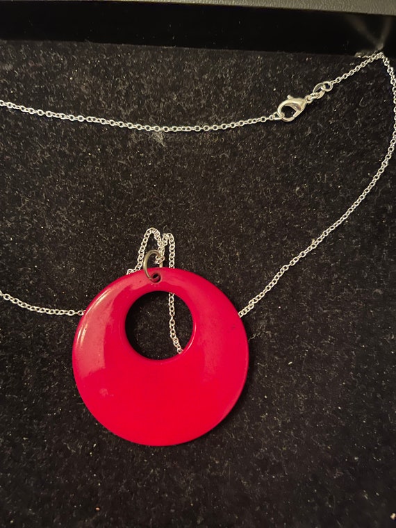 Red Oval - well made with a silver tone 22" chain 