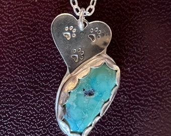 Love your pets? This Sterling Silver Heart has paw prints with a Blue Turquoise stone