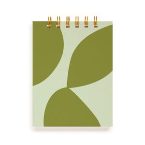May include: A green and white spiral bound notebook with an abstract design of overlapping green shapes.