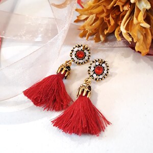 Red Tassel earrings,  Red glass set in gold plated stud setting with red tassel and gold plated cap