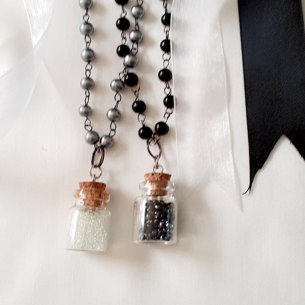 Necklaces, black or gray beads, pearls, little apothecary jars, cork stopper, crystals, lobster claw clasp