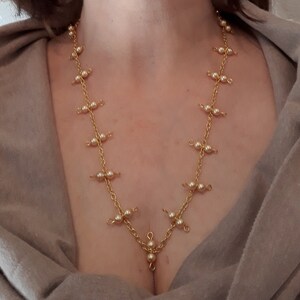 Gold chain necklace with gold pearl accents and gold-plated toggle clasp