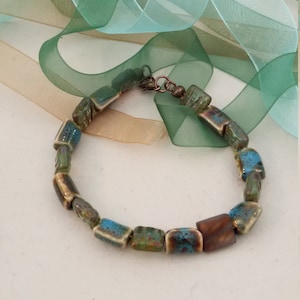 Casual elegance defines this bracelet, porcelain and lampworked beads with magnetic clasp
