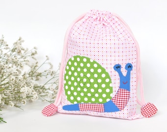 Handmade cotton snack bag with whimsical snail appliqué: perfect for Kids' adventures.