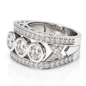 A silver ring with three large diamonds set in a decorative band.
