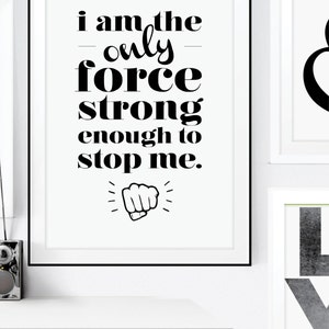 May include: Black and white motivational quote print with the text "I am the only force strong enough to stop me." and a black fist graphic.