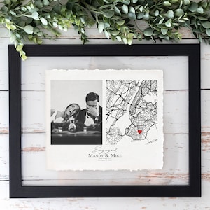 May include: Black framed print featuring a black and white photo of a couple laughing, and a map of New York City with a red heart. The print includes the text "Engaged" and names "Mandy & Mike".