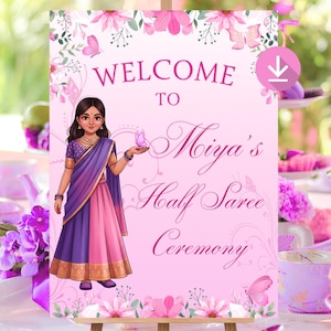 May include: A pink welcome sign on a wooden easel, featuring floral and butterfly designs. The sign reads "Welcome to Miya's Half Saree Ceremony" with an illustration of a girl in traditional attire. The background is a soft pink.