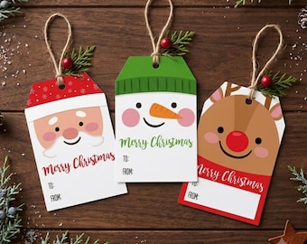 May include: Three rectangular gift tags with jute twine loops. One features a Santa Claus face, one a snowman with an orange nose, and one a reindeer with a red nose. Each tag displays the text Merry Christmas, To, and From, with green sprigs.