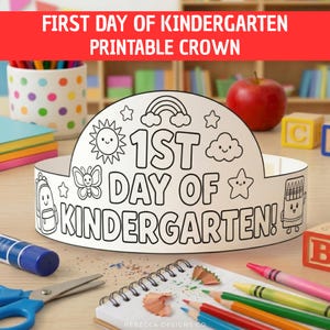 May include: A white paper crown with black line art for coloring, featuring the text 1ST DAY OF KINDERGARTEN! and illustrations of a sun, rainbow, cloud, butterfly, star, backpack, and crayon box, designed as a printable activity for children.