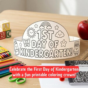 May include: A white paper crown for coloring featuring the text 1ST DAY OF KINDERGARTEN! surrounded by black line art illustrations of a sun, rainbow, stars, clouds, a butterfly, a backpack, and a crayon box on a curved band design.