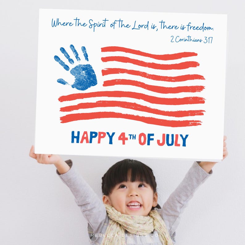 May include: A white sign with a handprint flag design in red and blue, with the text "Happy 4th of July" and a Bible verse. A child is holding the sign with arms raised.