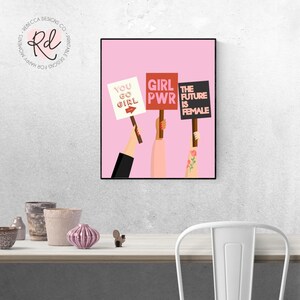 May include: Three hands holding signs with feminist slogans on a pink background. The signs read "You Go Girl", "Girl PWR", and "The Future is Female".