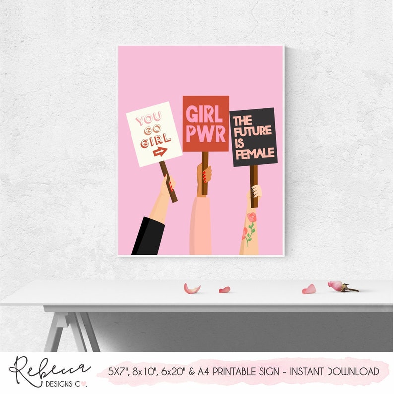 May include: Printable sign with three hands holding signs that say "You Go Girl", "Girl Power", and "The Future is Female". The signs are on a pink background.