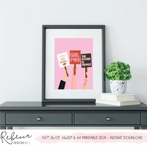 May include: Printable sign with a pink background and three illustrations of hands holding signs with the text "You Go Girl", "Girl PWR", and "The Future is Female".