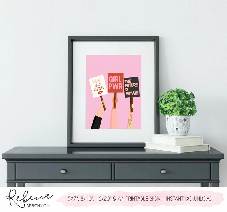 May include: Printable sign with a pink background and three illustrations of hands holding signs with the text "You Go Girl", "Girl PWR", and "The Future is Female".