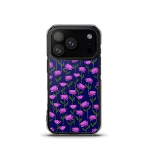 May include: A clear phone case with a dark blue background featuring a repeating pattern of pink flowers with green stems and leaves. The phone's camera lenses are visible at the top.