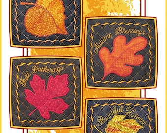 May include: Set of four quilted fabric coasters featuring embroidered autumn leaves and fall-themed text. The coasters are black with gold stitching and feature the text "Glorious Fall", "Autumn Blessings", "Fall Gatherings", and "Bountiful Harvest".