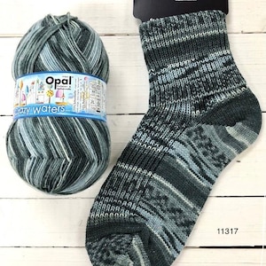 May include: A ball of Opal Crazy Waters yarn in shades of green and blue, with a knitted sock in the same colourway. The yarn label reads "Opal Pullover & Sockenwolle" and the sock has the number 11317 printed on the heel.