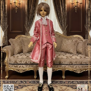May include: A doll wearing a pink Rococo suit with white trim, a white cravat, and black shoes. The suit includes a long coat, vest, and breeches. The doll has short, light brown hair. The text on the image reads "1/3 BJD Rococo Suit Style A".