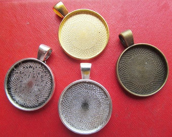May include: Four round metal pendant trays with a decorative swirl pattern. The trays are silver, gold, and two shades of bronze.
