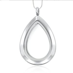 May include: A silver teardrop-shaped locket pendant with a clear glass insert. The locket is on a silver chain.