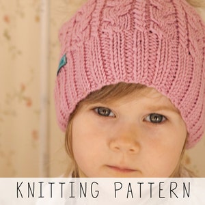 girl in pink cable hat, knitting pattern to make kids slouch beanie with cables
