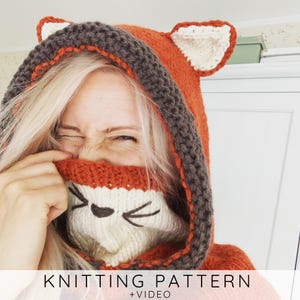 May include: A knitted fox hood in orange, brown, and cream colors. The hood features fox ears and a face design with a black nose and whiskers. The text "KNITTING PATTERN +VIDEO" is at the bottom.