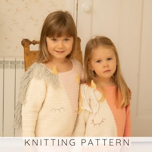 May include: Two long-sleeved sweaters featuring a unicorn design with a cream and pastel pink or coral color block pattern. Each sweater includes a yellow horn, a fringe mane, and embroidered closed eyes. The text KNITTING PATTERN is visible.