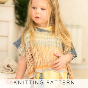 May include: A child wearing a knitted poncho with a gradient of colors, including yellow, orange, and blue. The poncho has a loose, open weave design and is trimmed with blue at the shoulders. The text "KNITTING PATTERN" is displayed at the bottom.