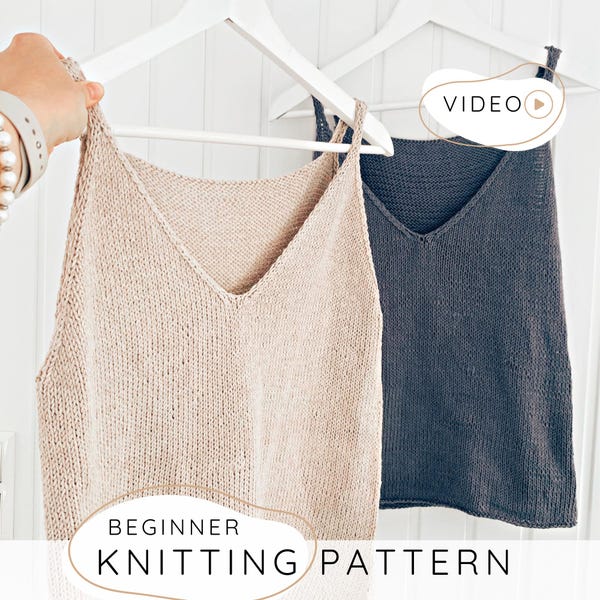 May include: Two knitted tank tops, one beige and one dark gray, hang on white hangers. The tops have a V-neck design. The text "BEGINNER KNITTING PATTERN" is displayed at the bottom of the image, with a "VIDEO" icon in the upper right corner.
