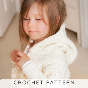 May include: A cream-coloured crochet hooded jacket. The jacket has a textured stitch pattern and a hood. The image includes the text "CROCHET PATTERN" at the bottom. The jacket appears to be for a child.