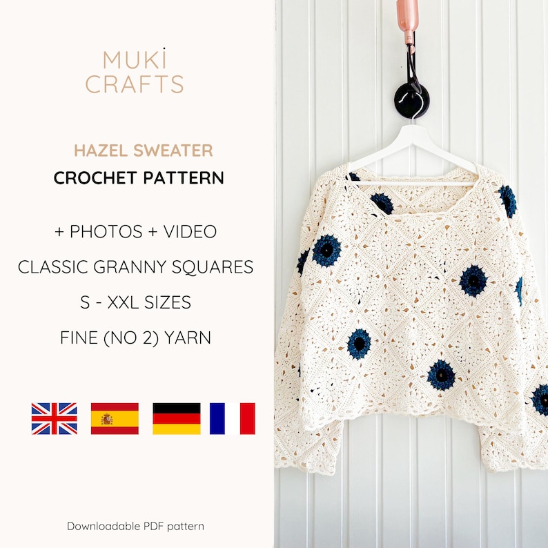 May include: Cream-colored crochet sweater with dark blue floral accents, hanging on a white hanger. The sweater is made of granny squares. The text on the image says "HAZEL SWEATER CROCHET PATTERN".
