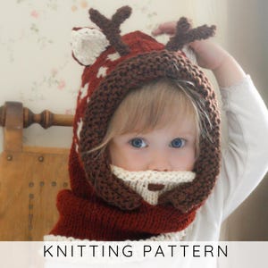 May include: A knitted reindeer hood in red, brown, and white, with antlers and a beard. The hood has a star pattern and covers the head and neck. The text "KNITTING PATTERN" is at the bottom. A cozy winter accessory.