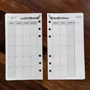 May include: Two-page spread of a 2026 planner insert. The left page is labelled "April" with a floral design and the days of the week. The right page is labelled "2026" with a floral design and the days of the week. The pages are white with a grid for each day.