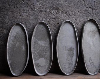 Organic natural shape elongated stoneware plates in grey cream, minimalist monochrome handcrafted handmade  pottery