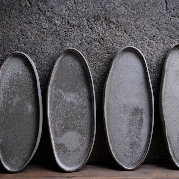 Organic natural shape elongated stoneware plates in grey cream, minimalist monochrome handcrafted handmade  pottery