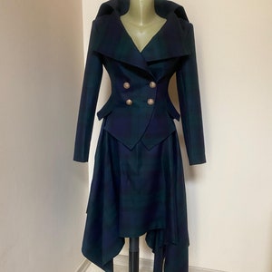 May include: A black and green plaid blazer and skirt set with a wide collar and gold buttons. The skirt is asymmetrical and has a longer back hem.