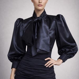 May include: A black satin blouse with a high collar and a large bow. The blouse has long, puffed sleeves and is paired with a dark skirt. The outfit is elegant and formal, suitable for evening wear.