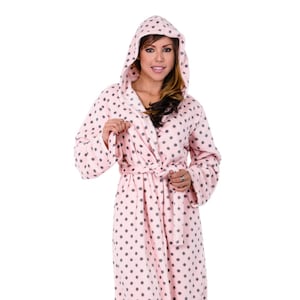 May include: A pink and gray polka dot robe with a white hood. The robe has a tie belt and long sleeves.